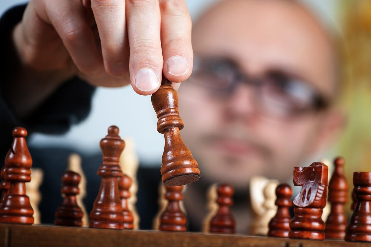 premium-seo-strategy-chess-strategic-thinking Hand moving chess piece representing strategic premium SEO services and high-level thinking for Tasmania business growth
